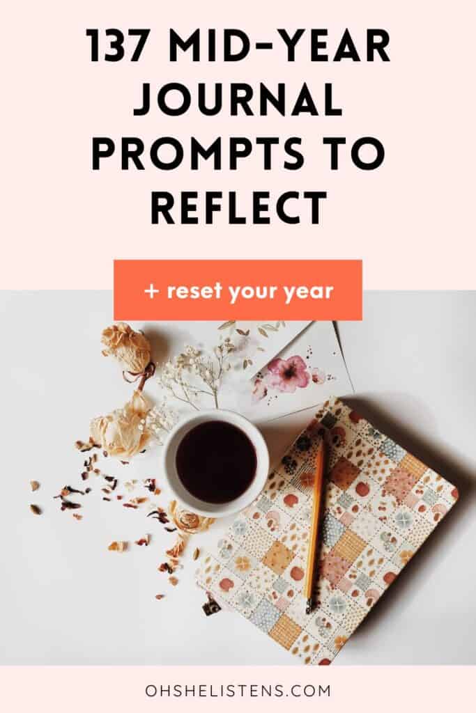 Flat lay of a colorful journal and coffee cup on a white table with a soft pink background. Text overlay reads: “137 Mid-Year Journal Prompts to Reflect.